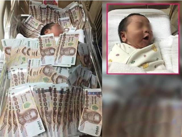 Sốc với cậu bé Thái Lan vừa ra đời đã được đắp tiền khắp người