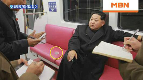 Kim Jong-un vứt tàn thuốc lá trên tàu gây tranh cãi - 1