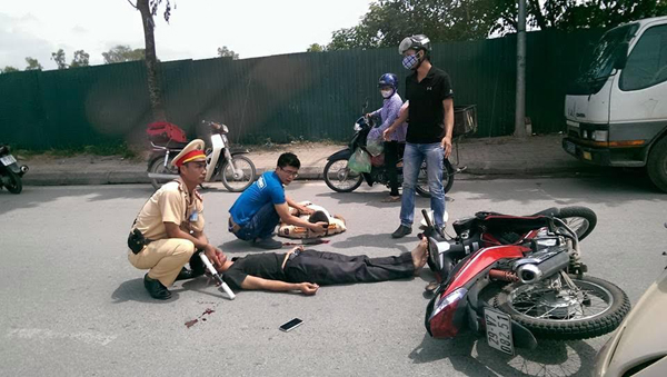 Lao xe máy vào CSGT, 2 người nhập viện - 1