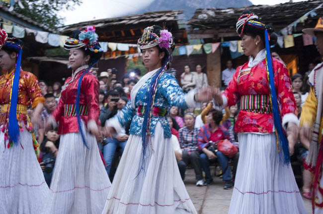 Các thành viên của bộ tộc Mosuo trình diễn múa lửa phục vụ du khách. Hoạt động du lịch mang lại nguồn thu đáng kể cho người dân ở nơi đây.