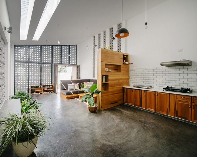 Gian bếp rộng được đặt ngay cạnh phòng khách, phân chia bởi một tủ gỗ đứng giúp không gian xuyên suốt liền mạch nhưng vẫn có sự riêng tư cần thiết.