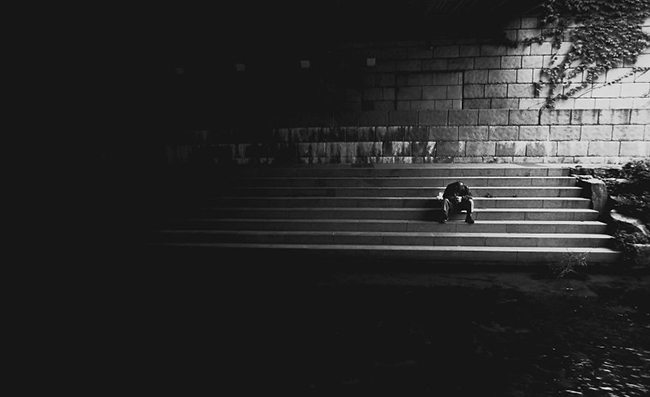 Một người đàn ông vô gia cư trông cô đơn vô cùng khi ngồi gục dưới gầm cầu.
