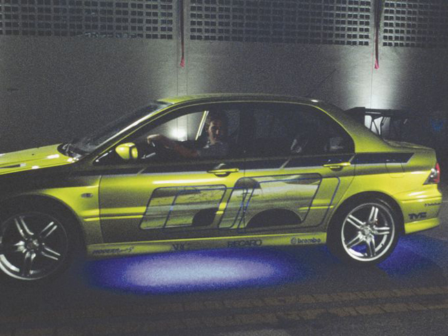 Paul Walker trong vai Brian O'Conner trên đường đua, lái xe Mitsubishi EVO 7  trong một cảnh của 2 Fast 2 Furious.

